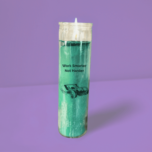 Lit version of Trill Spirituality's 7 day green glass abundance candle dressed in oils and herbs specifically to bring abundance